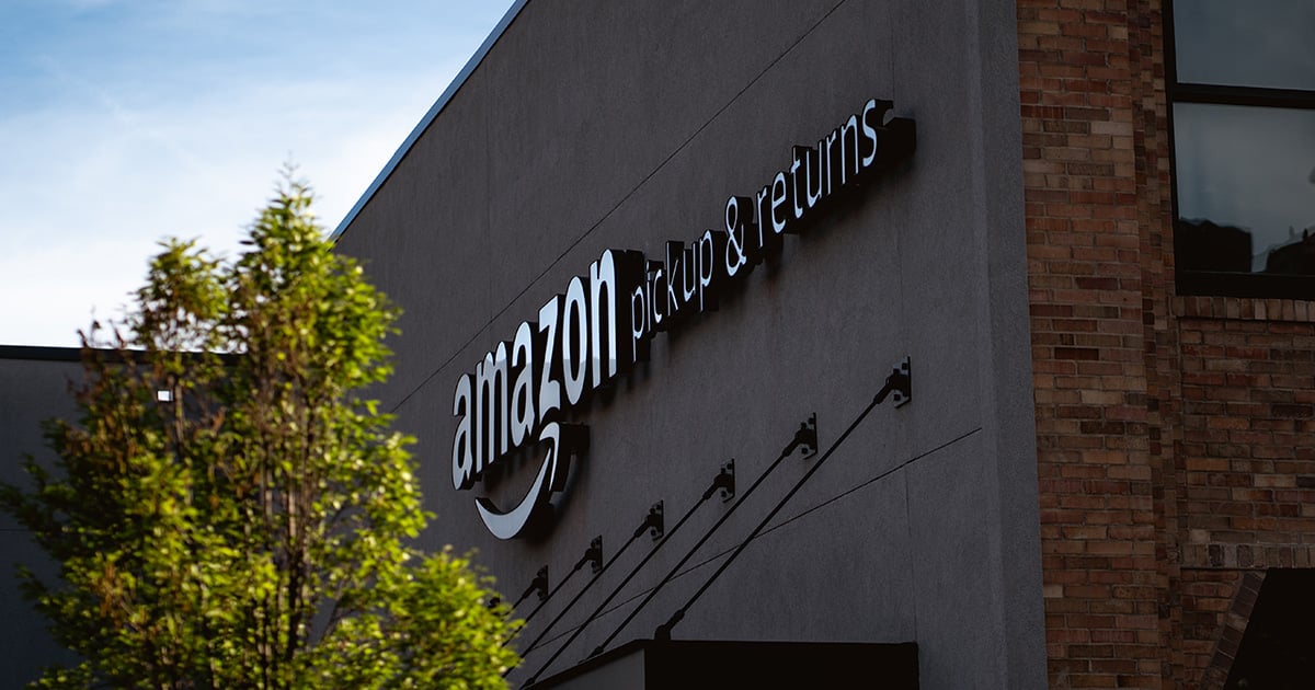 Amazon FBA drop-off returns sign on a building's exterior wall.